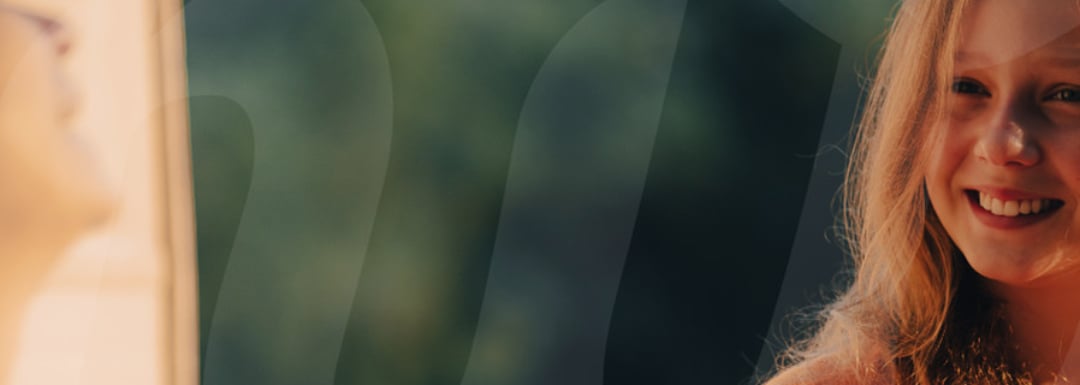 Close up of a young girl smiling.